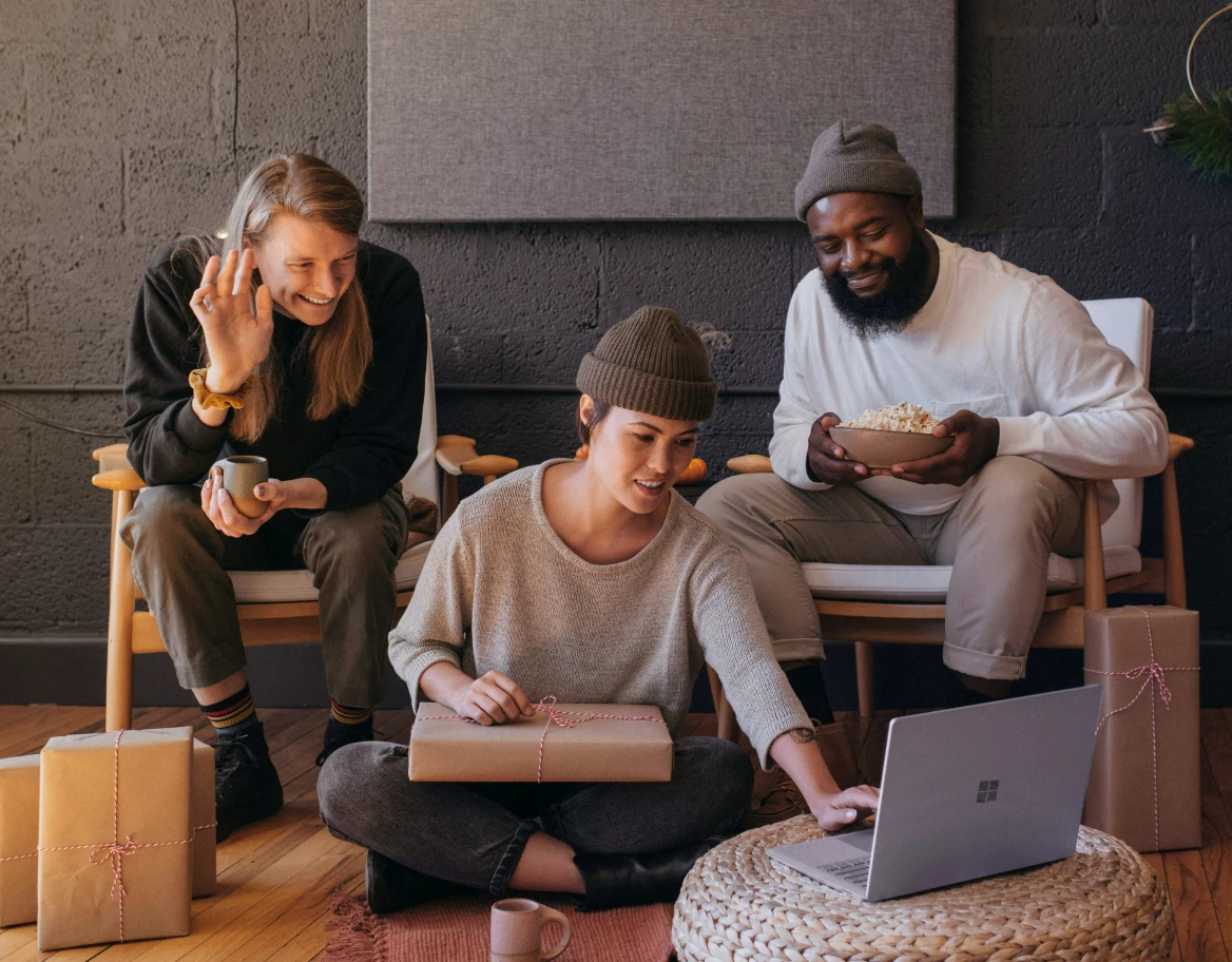 three group of people looking at a laptop